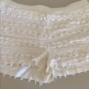 White fabric shorts with lace overlay